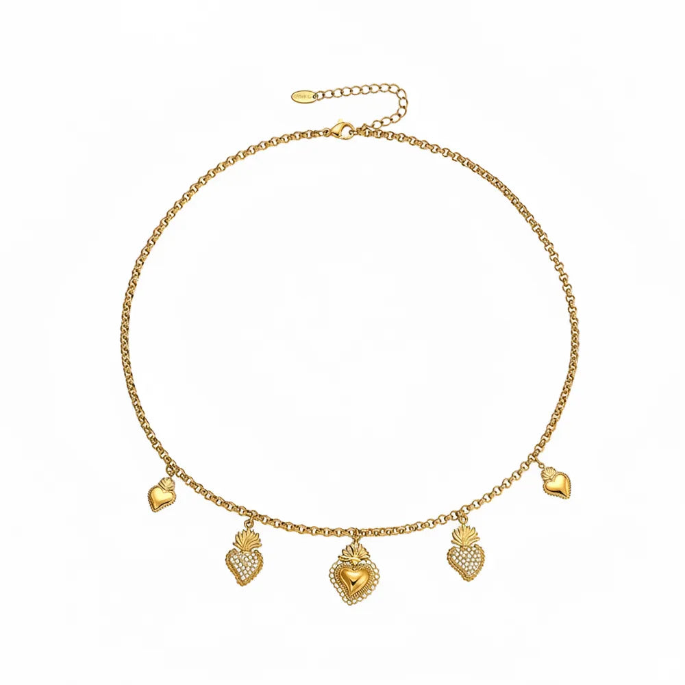 Gold charm necklace featuring alternating pavé and polished sacred heart pendants