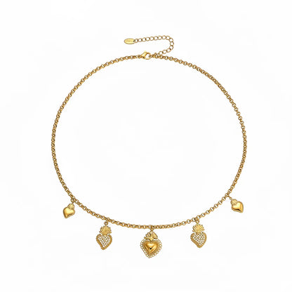 Gold charm necklace featuring alternating pavé and polished sacred heart pendants
