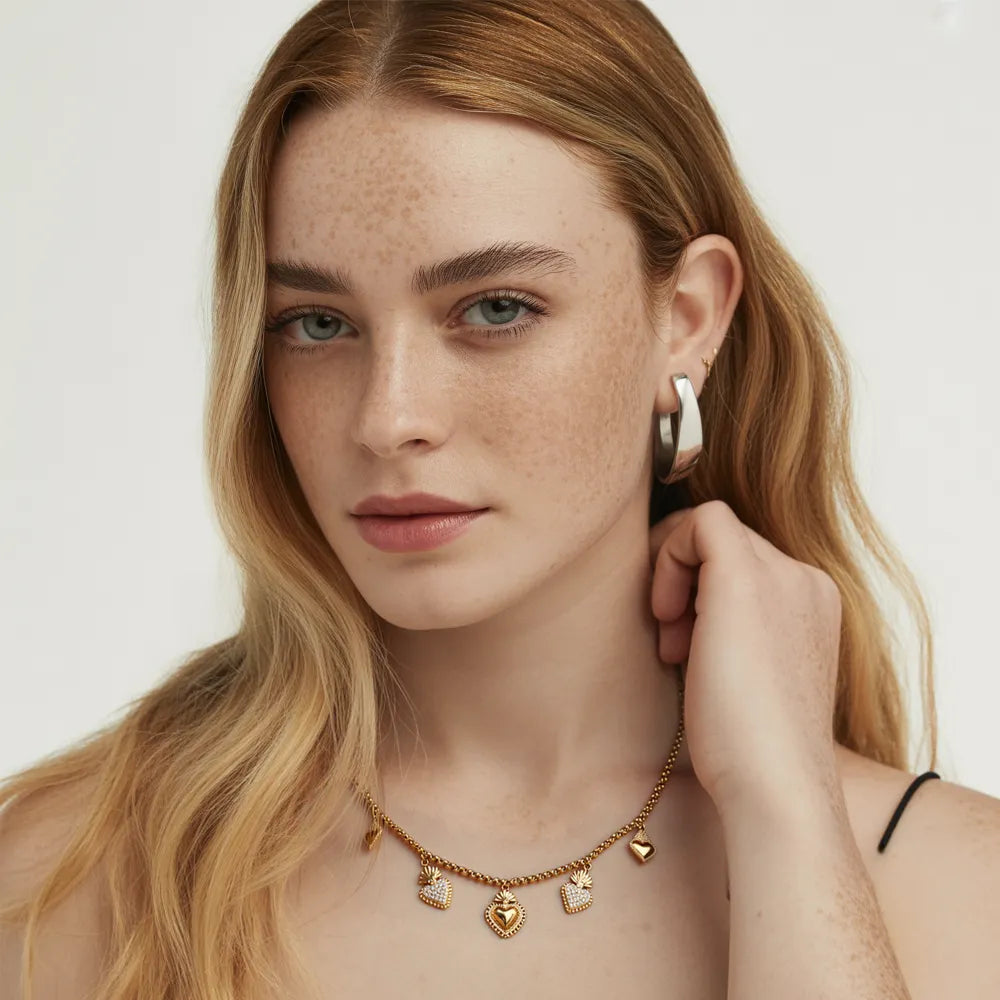 Woman showcasing the vintage style of the gold sacred heart charm necklace