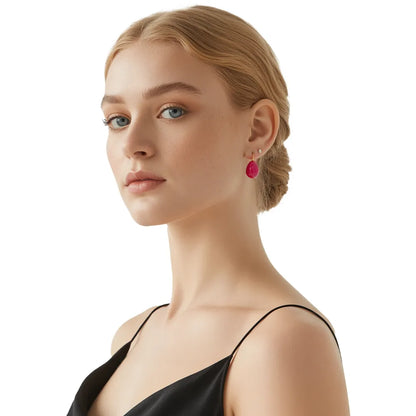 Woman with blonde hair showcasing the vibrant fuchsia teardrop dangle earrings.