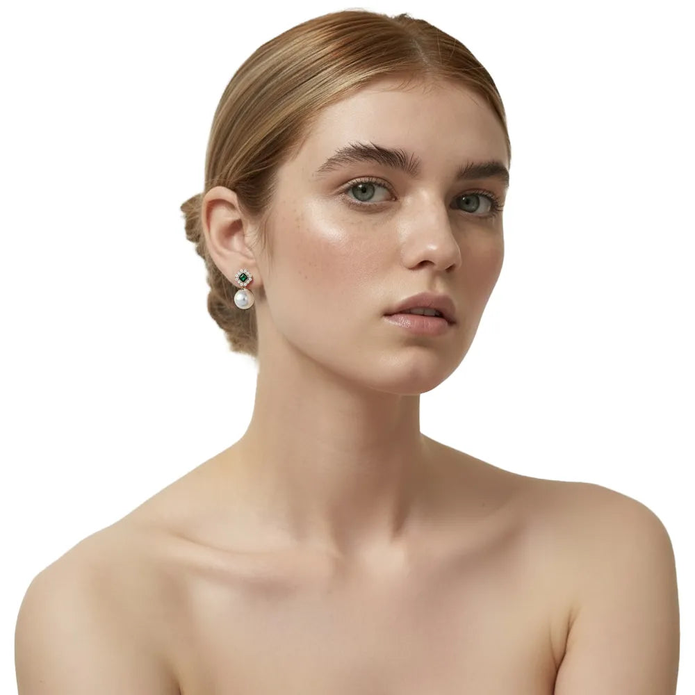 Redhead model wearing elegant S925 silver vintage emerald and pearl drop earrings.