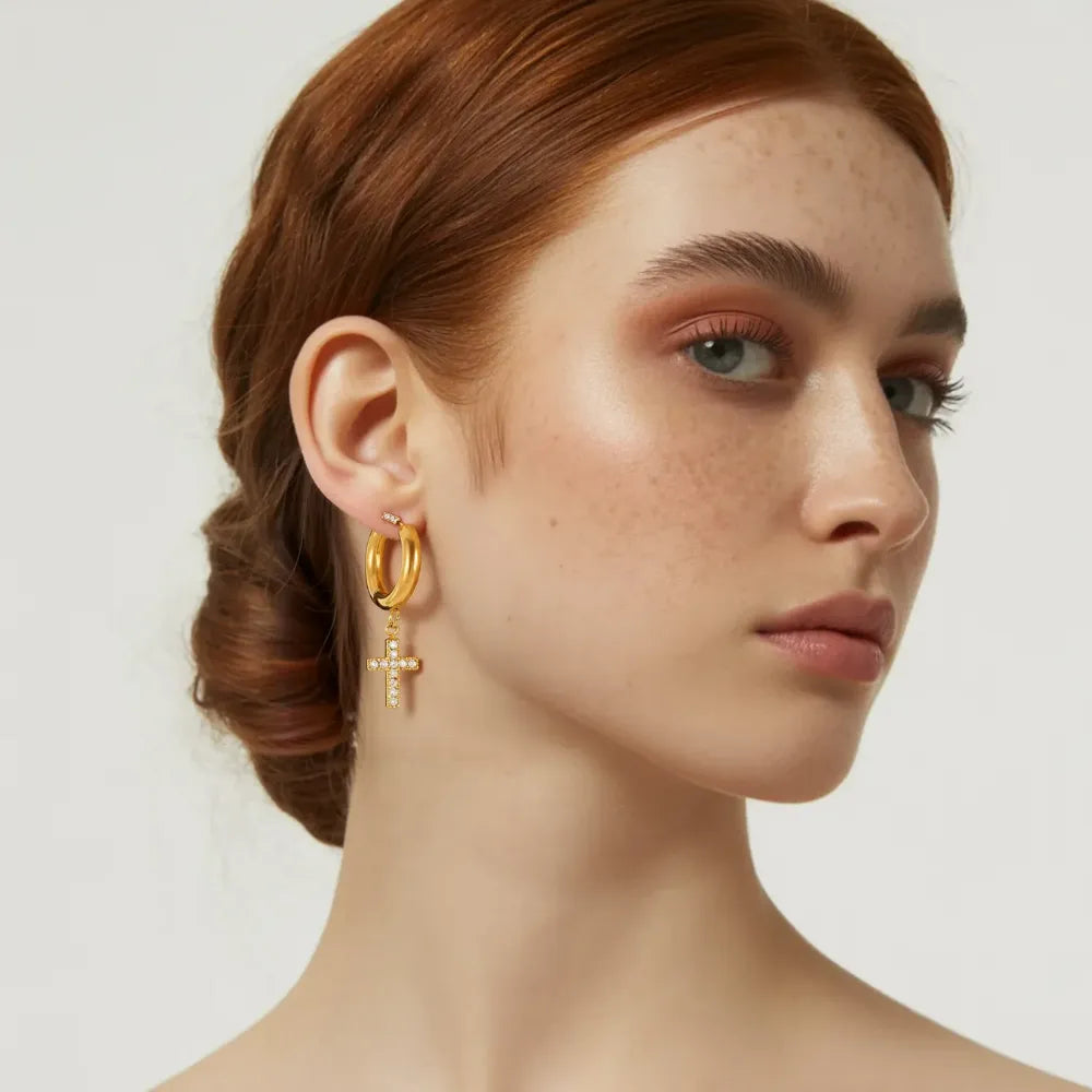 Model wearing 18k gold pavé cross hoop earrings.
