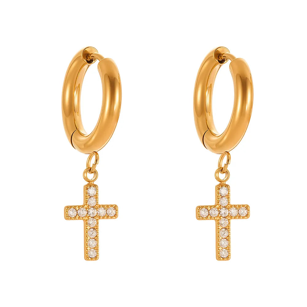 A pair of Faith Cross Hoop Earrings, with both the huggie hoop and the dangling cross fully encrusted with pavé zirconia.