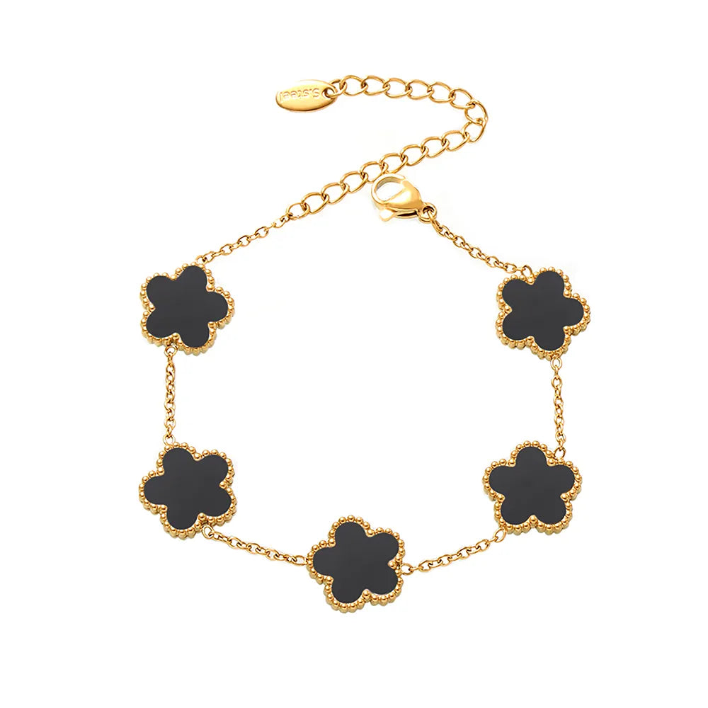 The Fleur Bloom Bracelet in 18k gold plate, featuring the five-petal flower design with a classic black agate stone, on a white background.