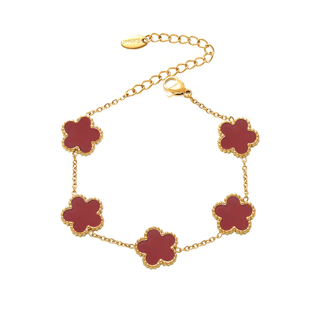 The 18k gold plated Fleur Bloom Bracelet featuring a bold red agate five-petal flower, shown on a white background