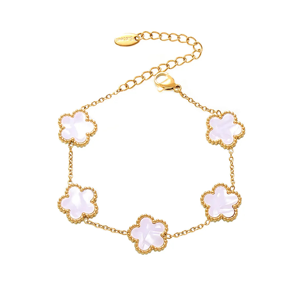 A product shot of the 18k gold plated Fleur Bloom Bracelet with an iridescent white seashell flower, on a white background.
