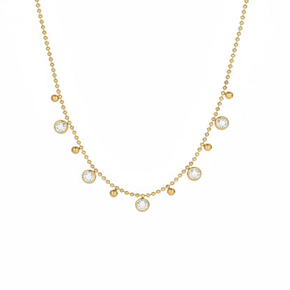 18K gold plated beaded chain necklace featuring dangling clear white cubic zirconia bezel charms isolated on white