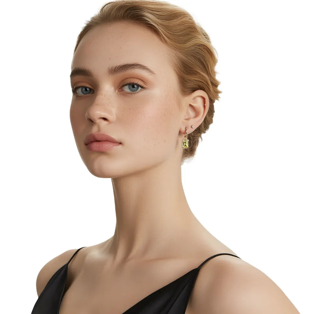 Blonde model showcasing 18K gold plated huggie earrings with a vibrant canary yellow rectangular stone