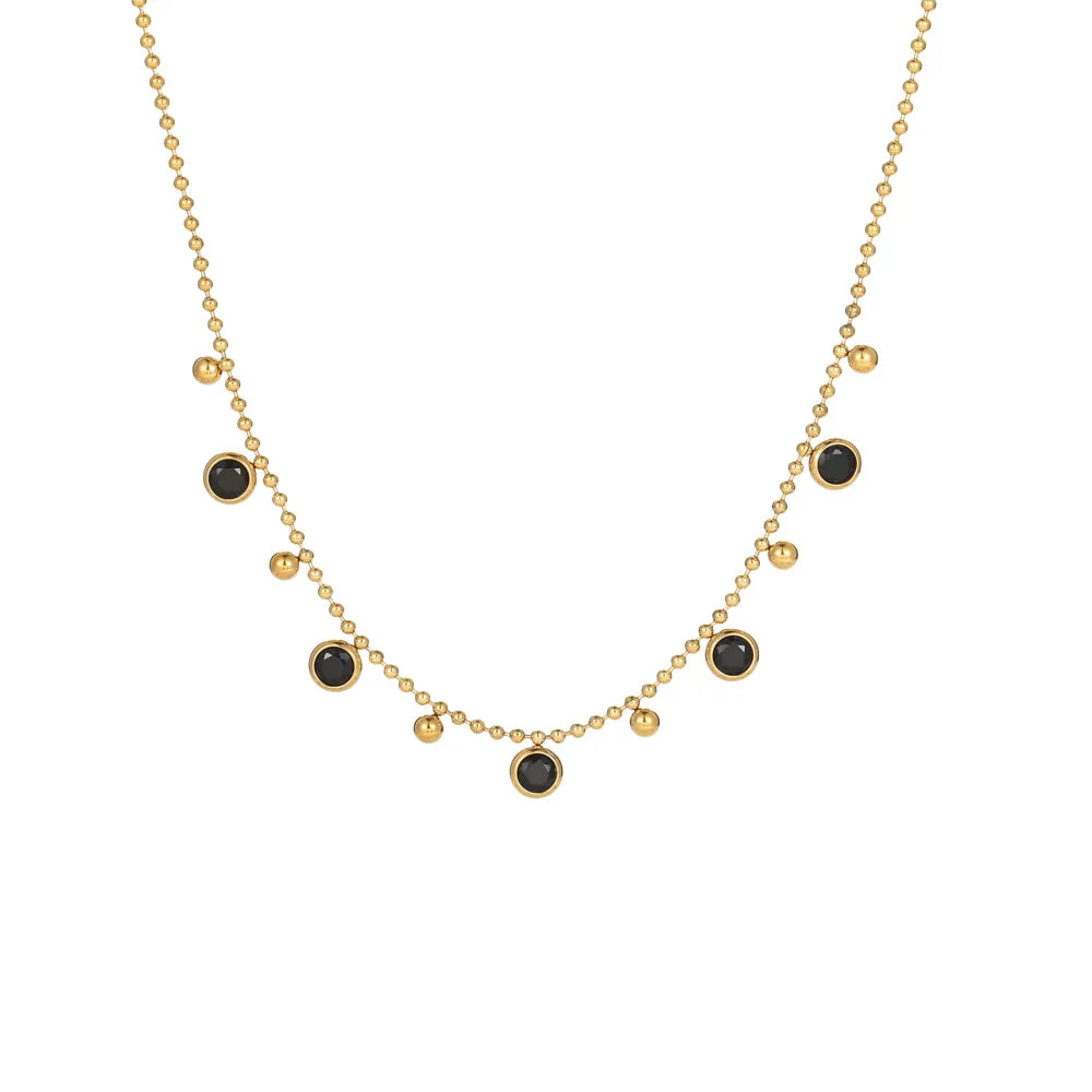 Gold stainless steel satellite chain necklace adorned with black cubic zirconia drop charms on a white background.