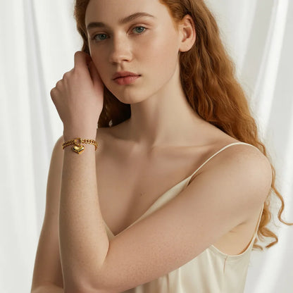 Close-up of the waterproof 18K gold plated bracelet on a model with a subtle top