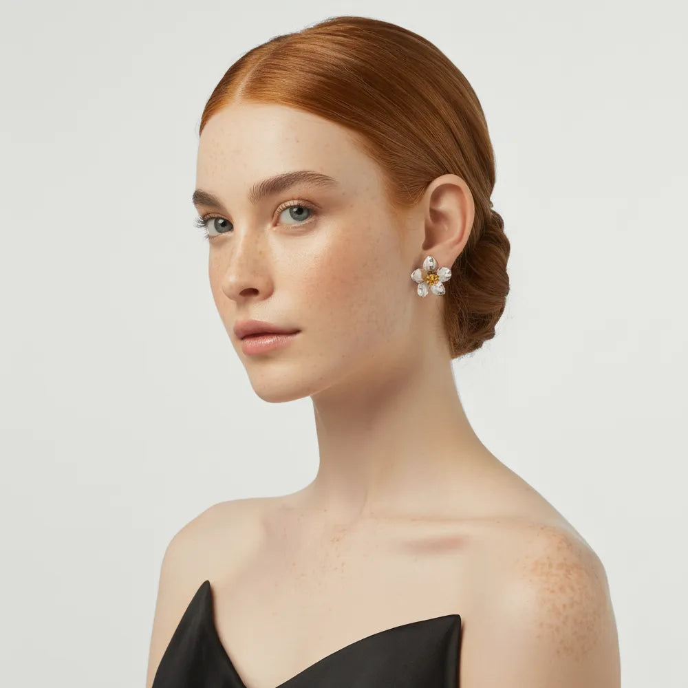 Model wearing the two-tone Helia Statement Flower Studs in silver and gold.