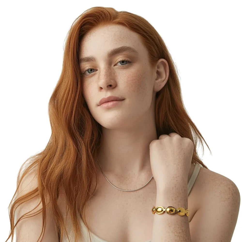 Model wearing the 18k gold plated Kalliope Pebble Cuff Bracelet for a statement look