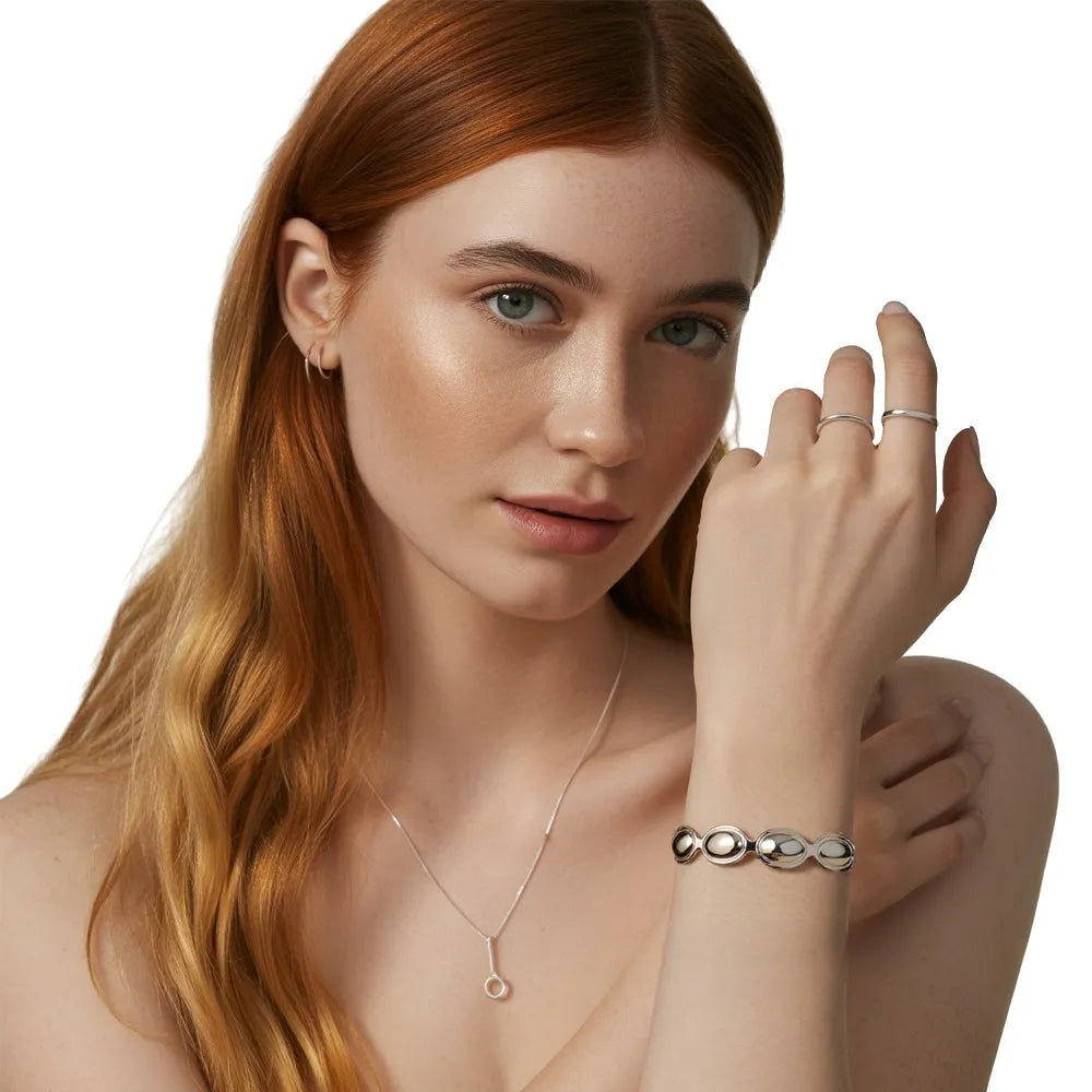 Model wearing the polished S925 sterling silver Kalliope Pebble Cuff Bracelet