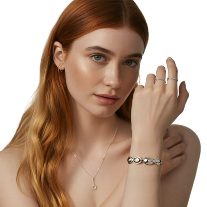 Model wearing the polished S925 sterling silver Kalliope Pebble Cuff Bracelet