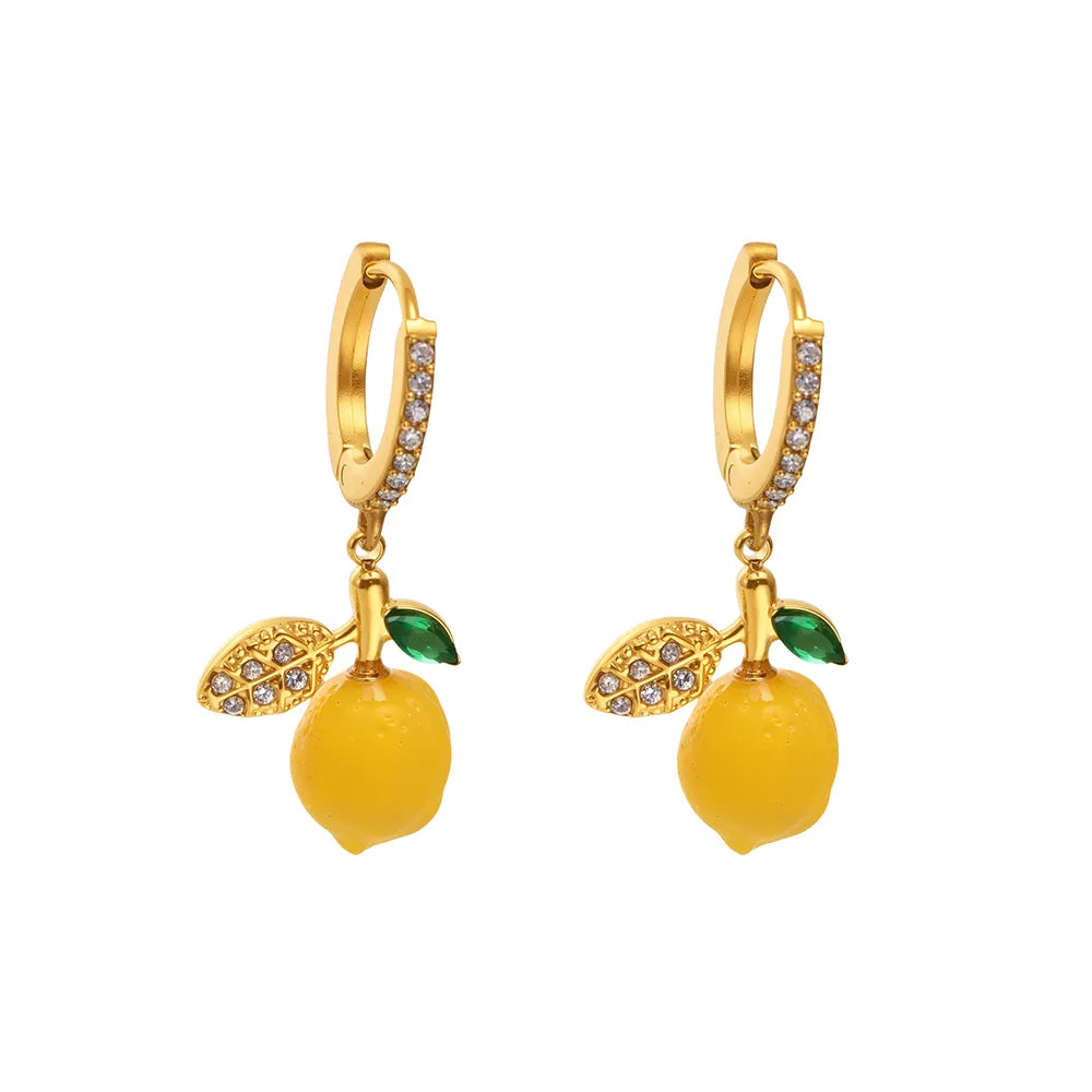 Pair of Lemon Zest Huggie Hoops in 18k gold with a yellow enamel charm and pavé zirconia.

