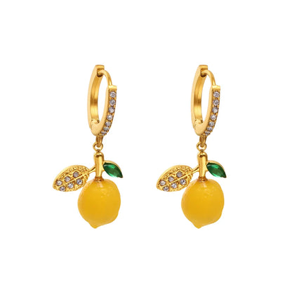 Pair of Lemon Zest Huggie Hoops in 18k gold with a yellow enamel charm and pavé zirconia.


