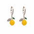 Pair of Lemon Zest Huggie Hoops in polished 316L stainless steel with a yellow enamel charm.