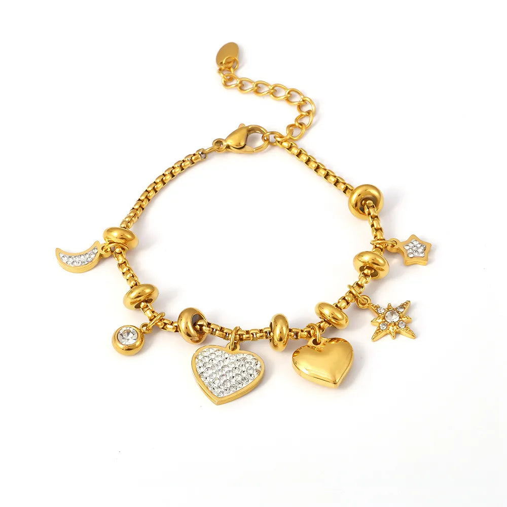 The Lennox Pavé Heart Bracelet in 18k gold plate, featuring a chunky curb chain and a sparkling zirconia heart, on a white background