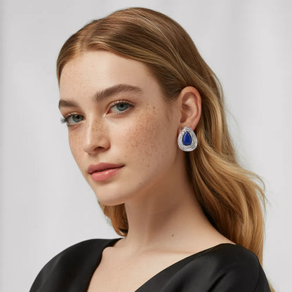 Model wearing the polished 316L stainless steel Lyra Goldstone Stud Earrings