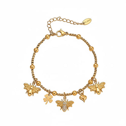 8k gold beaded bracelet with dangling bee, clover, and heart charms.