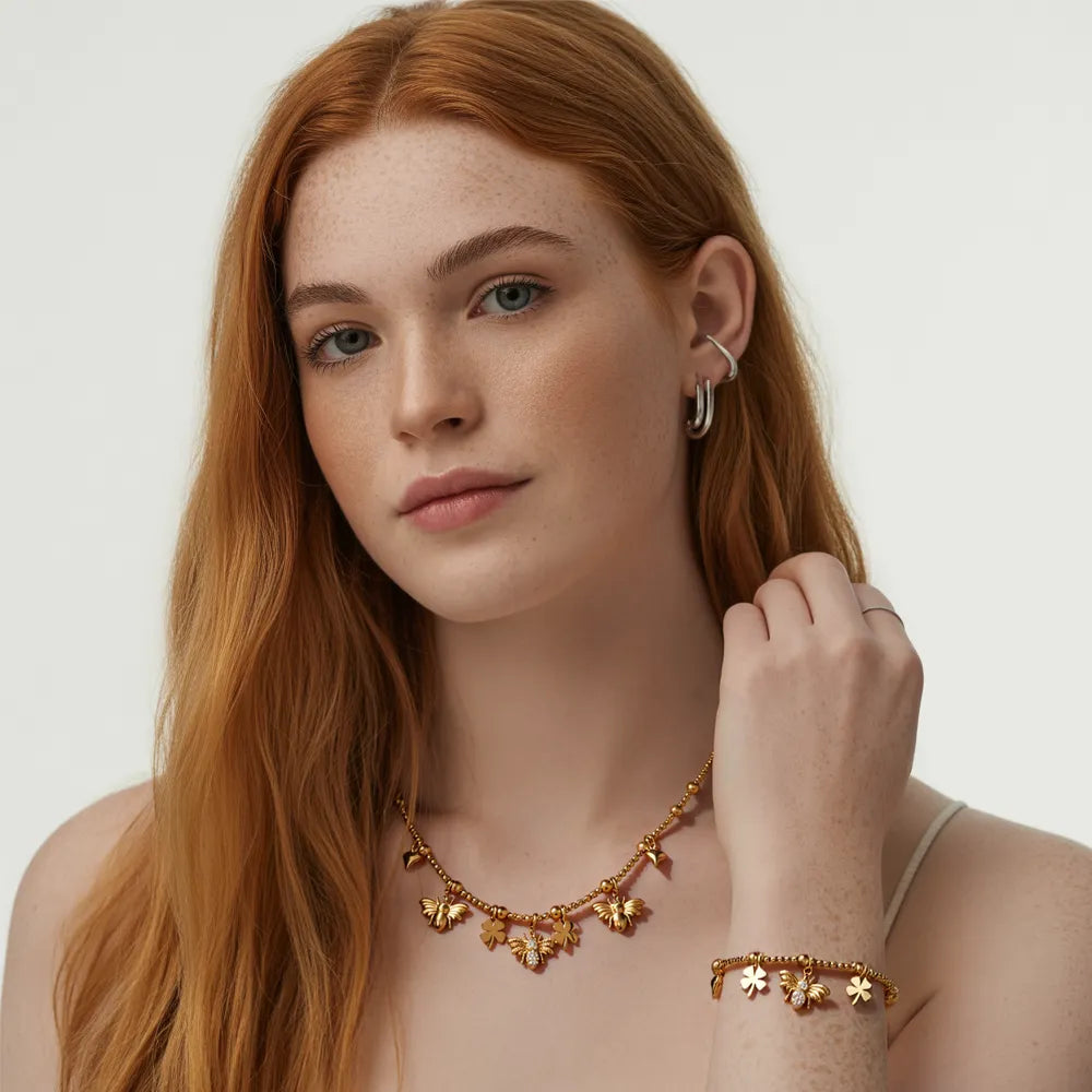 Model with red hair wearing the Melia Bee & Clover Charm Set, showing its whimsical style