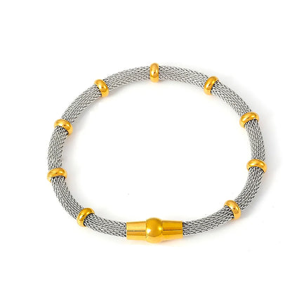 A product shot of the Milanese Weave Bracelet in a sophisticated two-tone (gold and silver) finish with bamboo details.