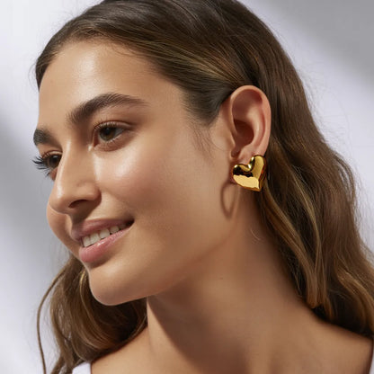 Model wearing the 18K gold Minimalist Heart Stud Earrings