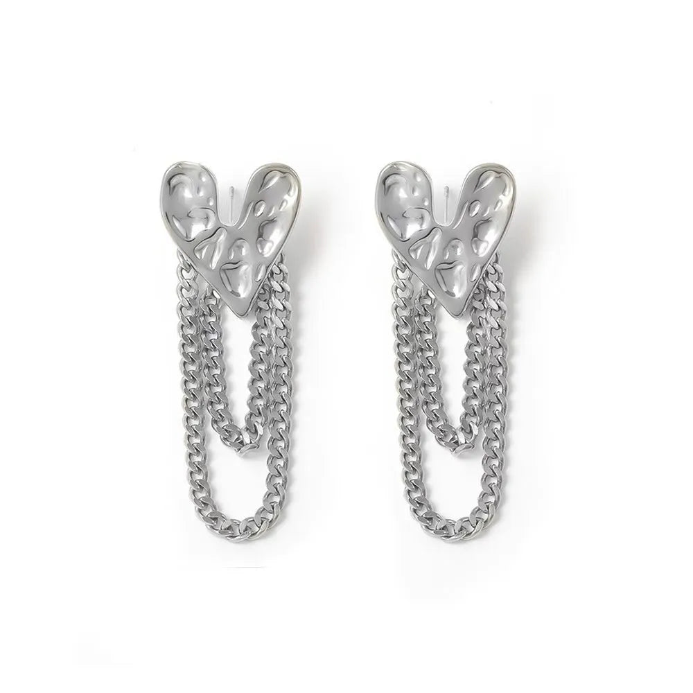 Polished 316L stainless steel heart stud earrings on a white background.