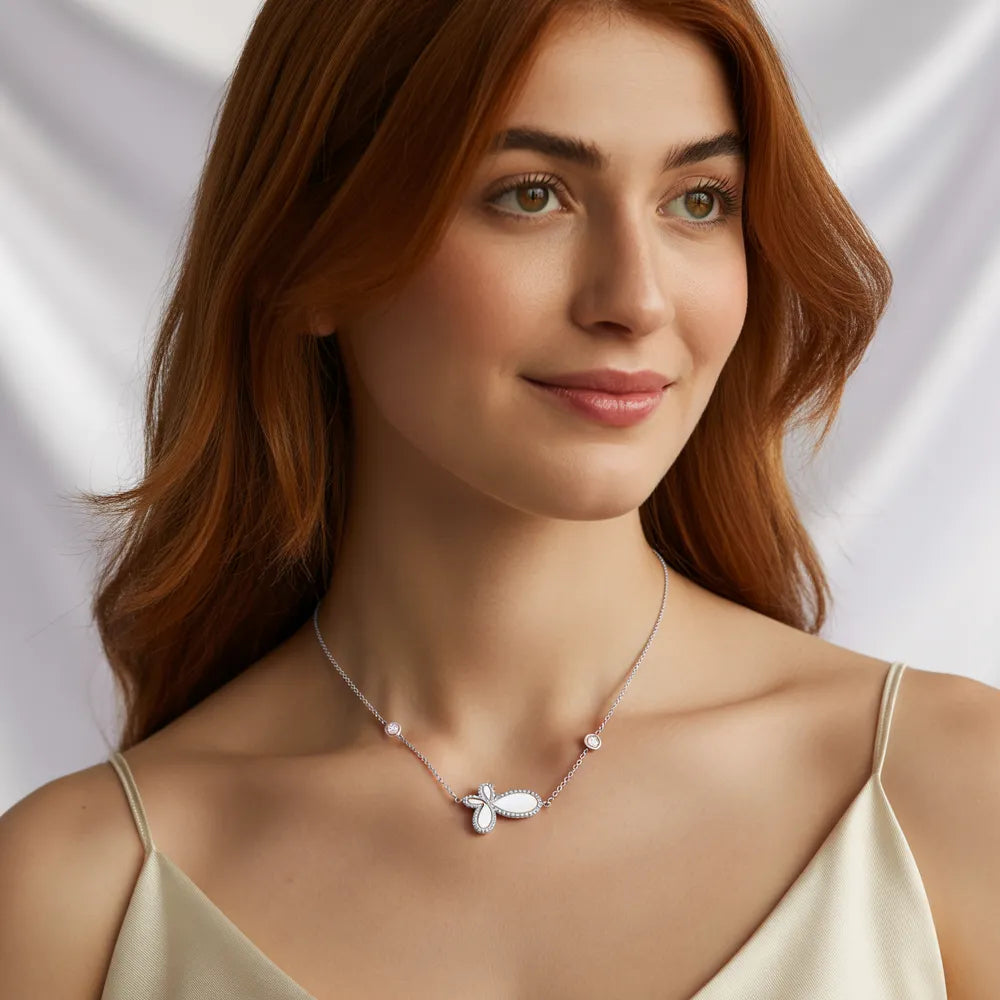 A woman wearing the 316L Stainless Steel butterfly and mother of pearl necklace