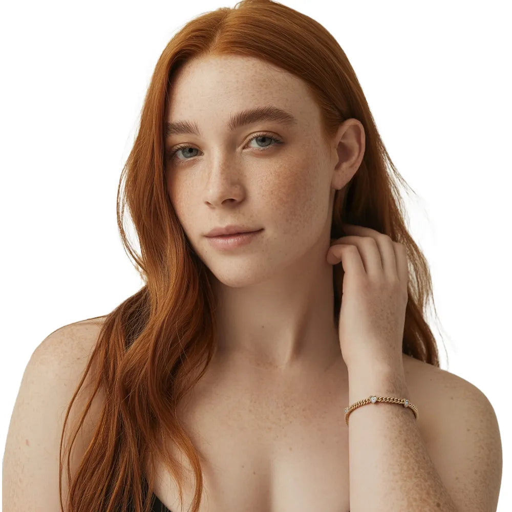 Redhead model wearing a gold Cuban chain bracelet with heart charms for a trendy look.