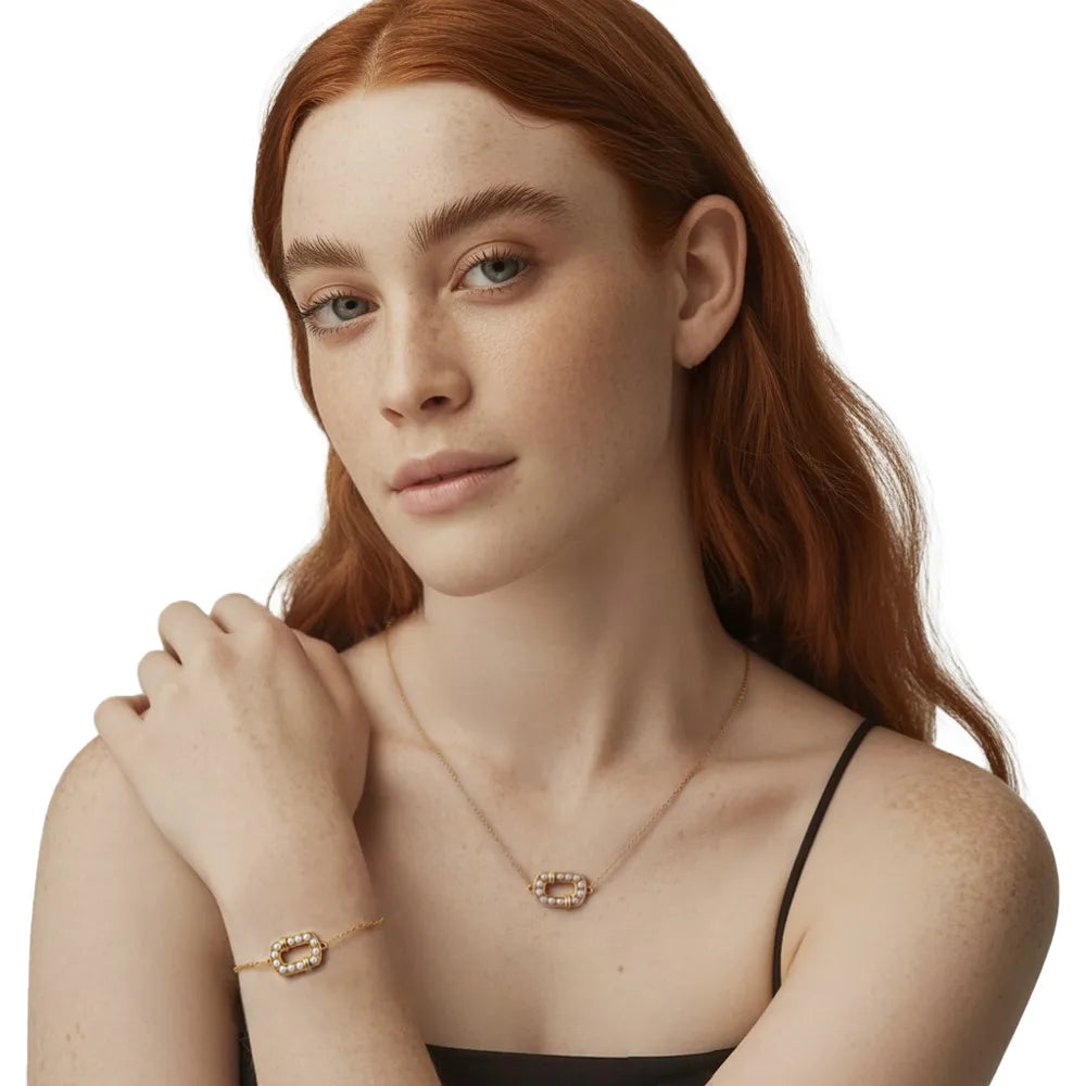 Model wearing the matching 18K gold plated oval pearl necklace and bracelet set.