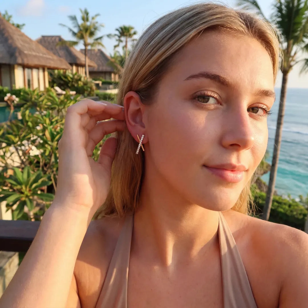 Model wearing chic gold X stud earrings with a natural makeup look.-03