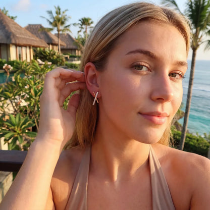 Model wearing chic gold X stud earrings with a natural makeup look.-03