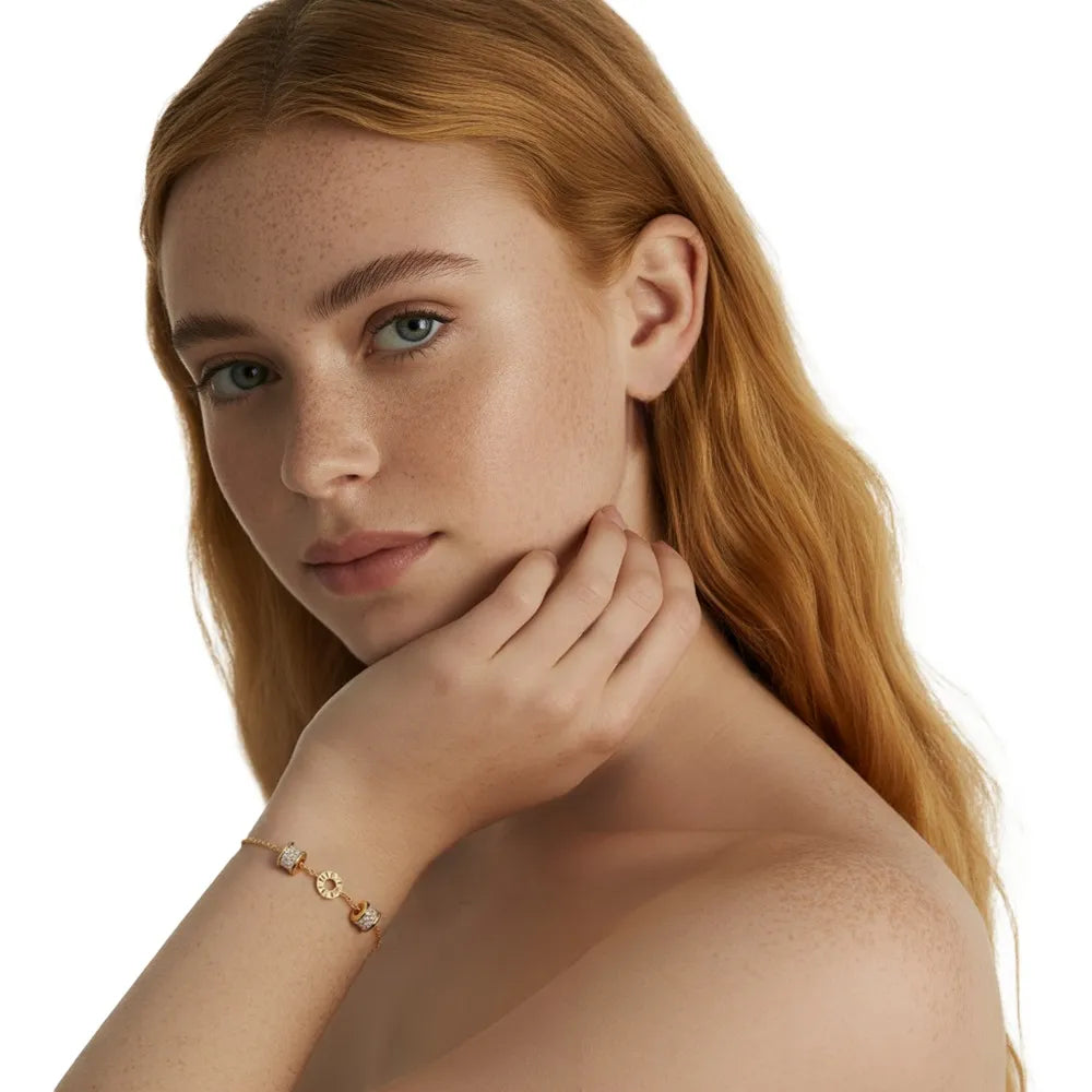 Redhead model wearing a trendy gold roman numeral station bracelet for good luck.
