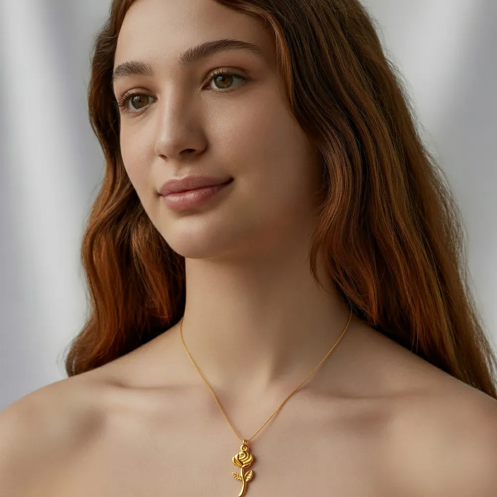 A model wearing the Rosa Geometric Rose Pendant Necklace with a white top to highlight its unique and artistic style