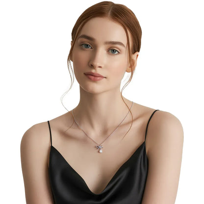 Close-up of redhead model wearing the hypoallergenic S999 silver pearl bow necklace.
