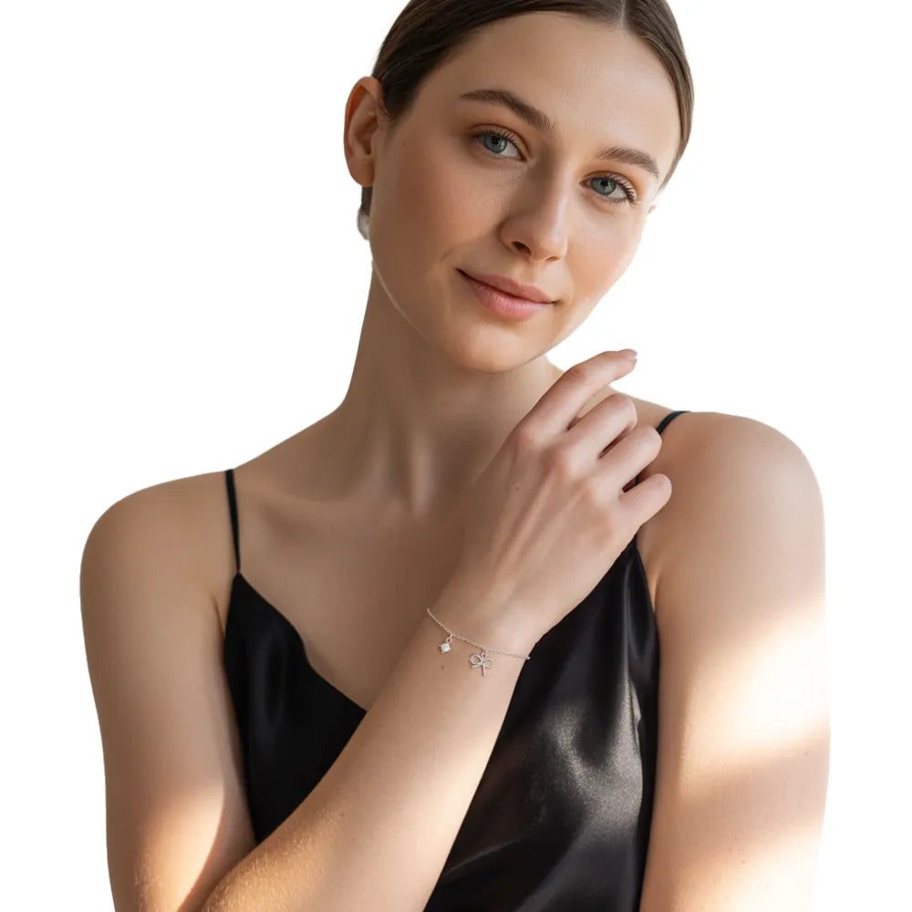 Model showcasing the elegant S999 fine silver bowknot bracelet as a charming accessory for a minimalist outfit