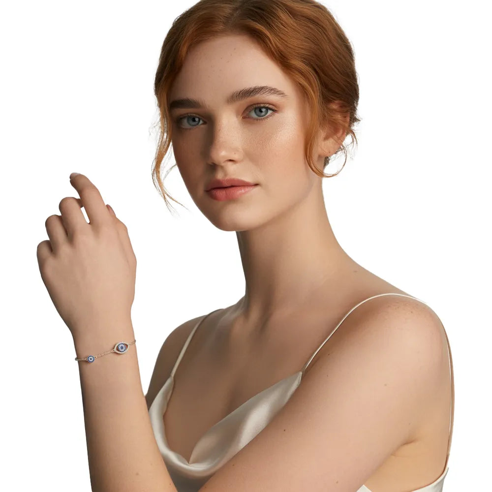 Redhead model wearing a silver double evil eye bracelet, adding a touch of mystique to her look