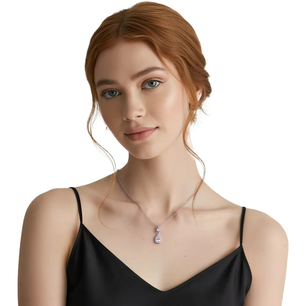 Woman showcasing a sophisticated silver teardrop pendant for evening wear.