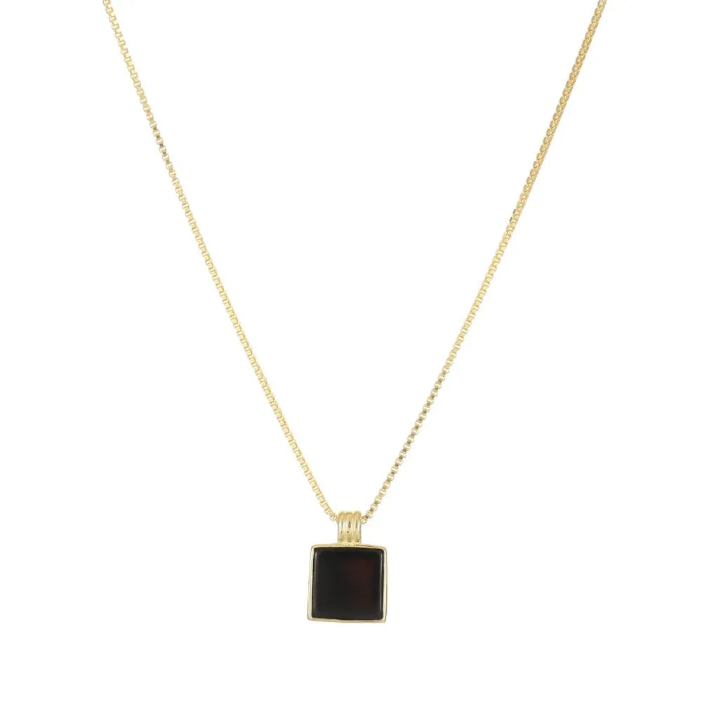 Sleek Onyx Square Tag Necklace in 18k gold plate over S925 silver on a white background
