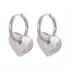 Polished 316L stainless steel hoop earrings with a dangling puffy heart charm.