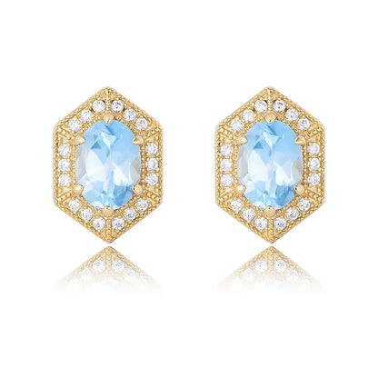 Front view of S925 sterling silver hexagon stud earrings featuring an oval-cut natural Blue Topaz gemstone and vintage gold detailing on a white background
