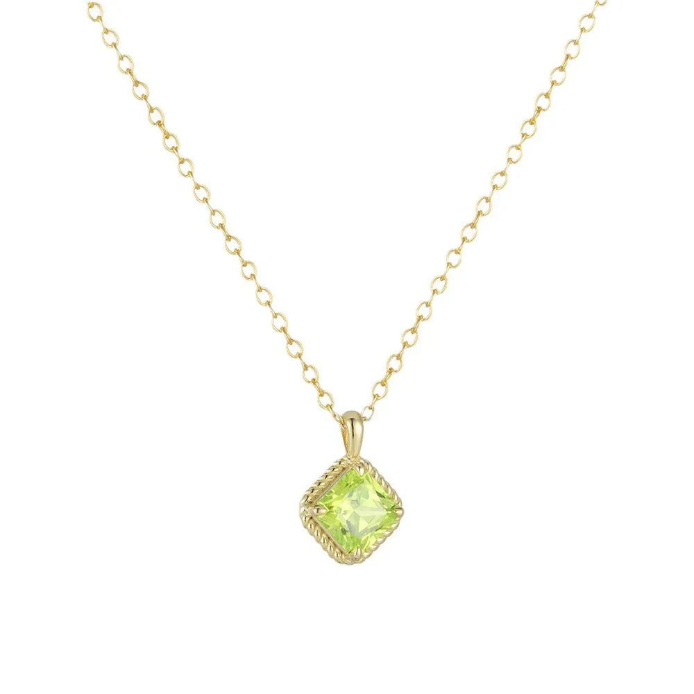 Dainty gold necklace featuring a vibrant green square zirconia pendant
