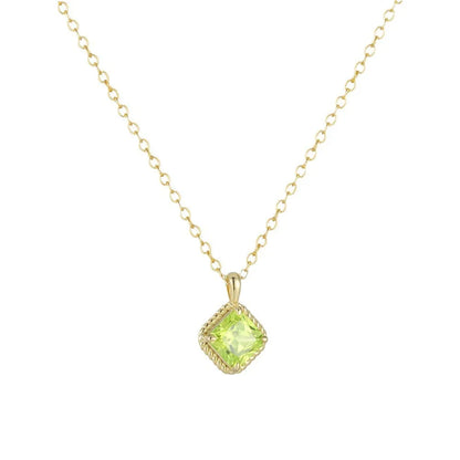 Dainty gold necklace featuring a vibrant green square zirconia pendant