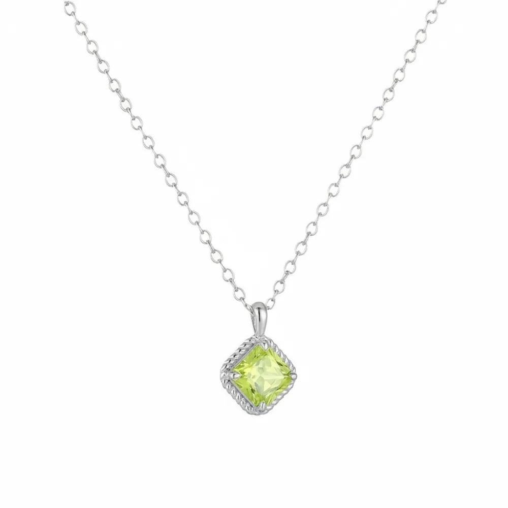 Elegant silver necklace featuring a sparkling green square stone pendant.