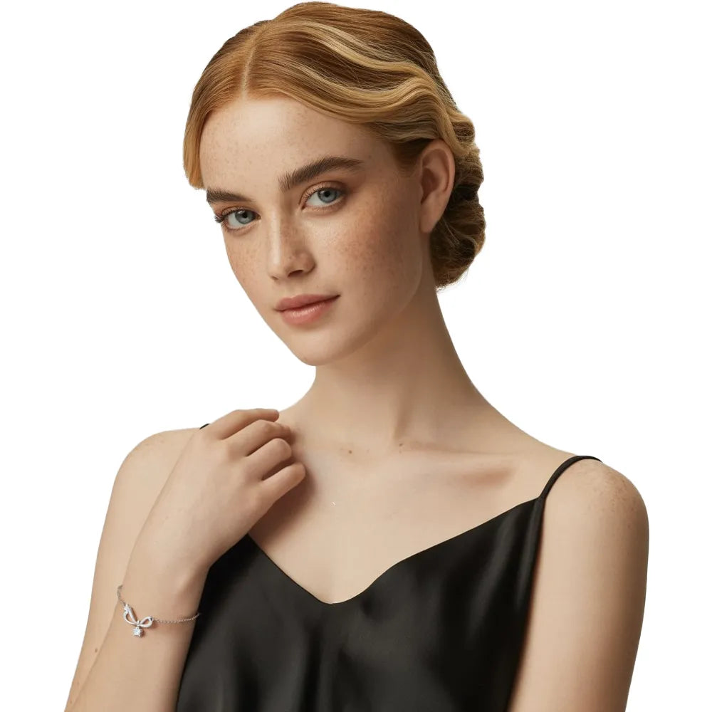 Model wearing the S925 Silver Pavé Infinity Bow Bracelet, showcasing its delicate fit on the wrist.