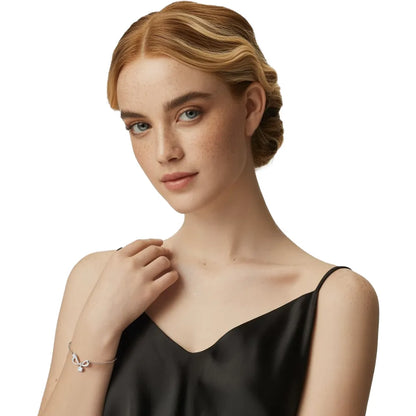 Model wearing the S925 Silver Pavé Infinity Bow Bracelet, showcasing its delicate fit on the wrist.