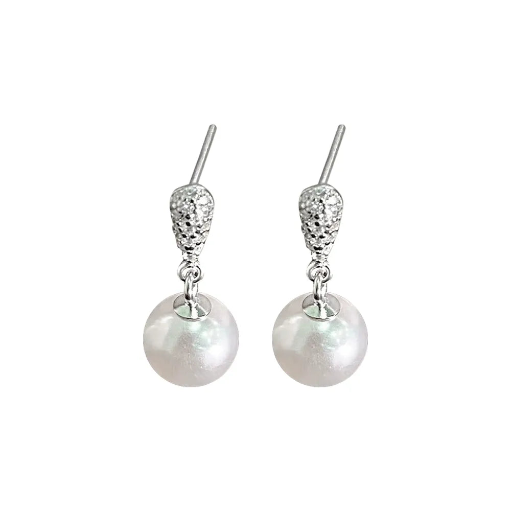 Pair of S925 sterling silver dangle earrings with a pavé zirconia top and a genuine pearl drop.