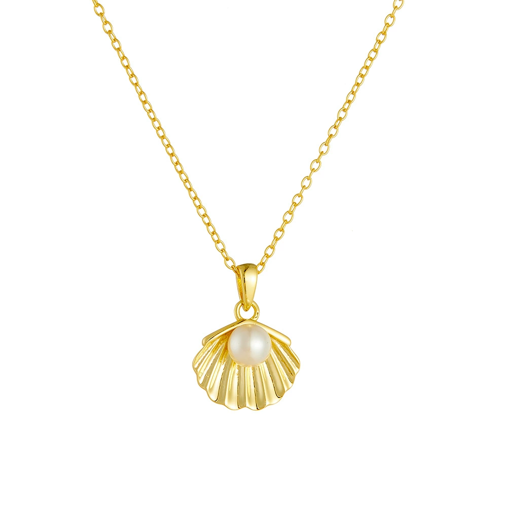 Close-up of the elegant gold necklace featuring a lustrous pearl and textured shell design.