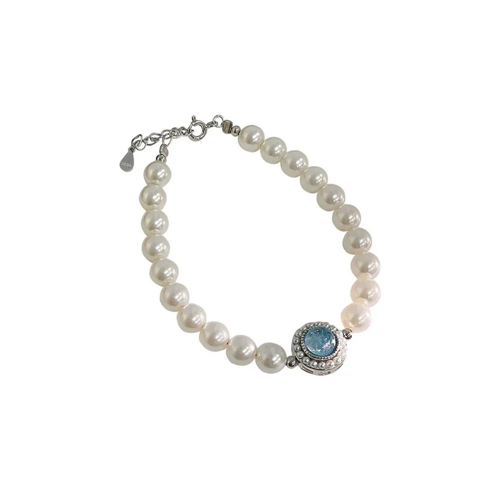 S925 sterling silver bracelet featuring a strand of white pearls and a vintage round aquamarine center stone